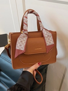 Brown litchi grain leather tote bag with geometric silk scarf and adjustable strap