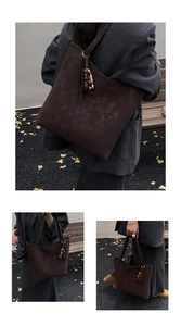 Detail of vintage brown suede tote bag featuring bohemian bead tassels and spacious interior