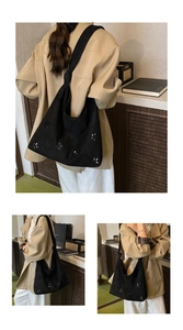 Detail of black hollow-out tote bag featuring floral laser cuts and knotted wide shoulder strap