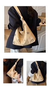 Close-up of light brown suede tote bag with laser-cut floral patterns and knotted strap