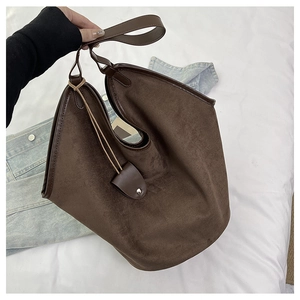 Detail view of large capacity dark brown faux suede hobo bag with leather trimming