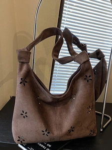 Dark brown hollow floral cutout shoulder bag with wide knotted strap and large capacity