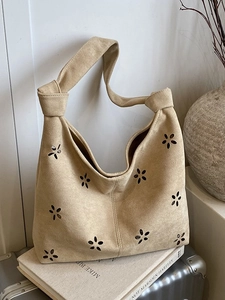 Hollow flower cutout suede shoulder bag in beige with knotted handle and hobo shape