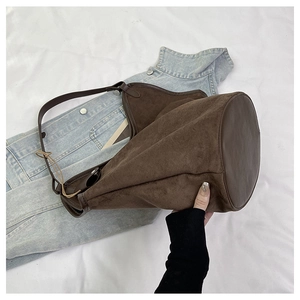 Top view of large brown suede bucket bag showing spacious interior and leather strap