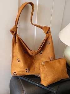 Caramel brown laser-cut tote bag set with matching pouch and knotted shoulder strap