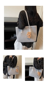 Detail of grey leopard embossed tote bag with MKLUOXI text and brown plush bear charm