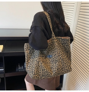 Close-up of leopard print tote bag featuring a front pocket and spacious shoulder design