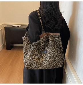 Detail of large leopard print tote bag showing canvas texture and spacious shoulder design