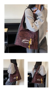 Detail of red leopard print tote bag with yellow tassel and black strap craftsmanship