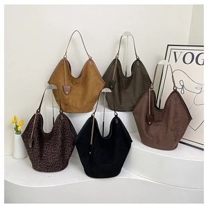 Multiple colors of vintage large capacity tote bags displayed on minimalist white stairs