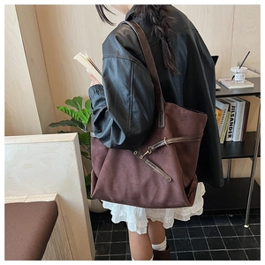 Detailed back view of a dark coffee tote bag styled with a leather jacket and white skirt