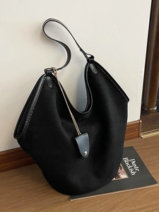 Large black vintage canvas tote bag with leather trim and decorative pendant