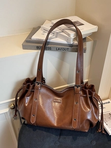 Retro dark brown leather tote bag with drawstring detail and metallic eyelets straps