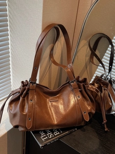 Brown vintage minimalist tote bag with drawstring leather texture and buckle details