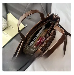 Macro view of dark brown woven texture tote bag interior showing spacious storage capacity