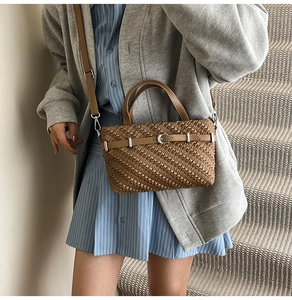 Brown woven texture handbag with leather straps shown in a lifestyle street style setting