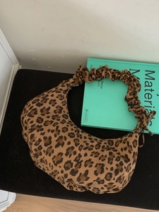 Fashionable leopard print crescent bag with ruched handle and vintage aesthetic style