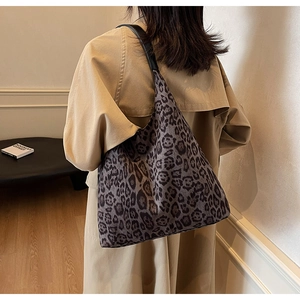 Detail of large leopard print hobo shoulder bag styled with a khaki trench coat