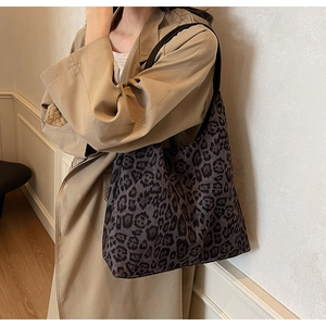 Leopard print tote bag styled with khaki trench coat for an urban commute look