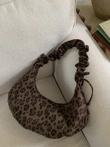 Leopard print crescent hobo bag with pleated shoulder strap and drawstring detail