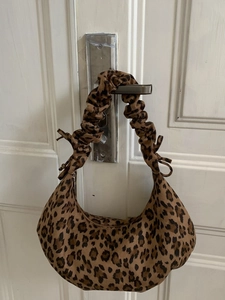 Leopard print crescent shoulder bag with scrunchie strap and tie-up side details