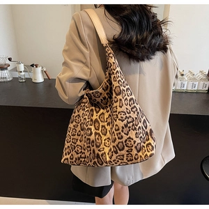 Close-up of leopard print canvas hobo bag with adjustable shoulder strap and texture