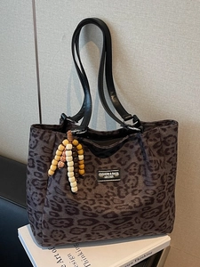 Chic leopard print tote bag with leather straps and wood bead charm for daily commute