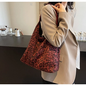 Detailed view of leopard print tote bag in premium fabric showing large capacity and strap