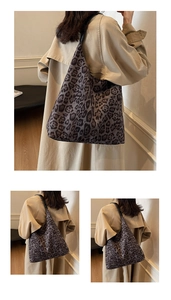Detail of large leopard print tote bag with black shoulder strap and soft canvas texture