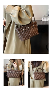 Detail of retro dark brown pleated Boston bag with metal buckle and adjustable strap