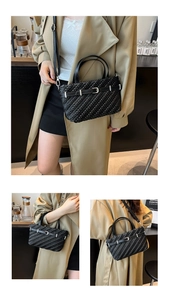 Detail of black woven Boston bag showing intricate texture and silver metal buckle accent