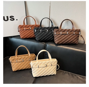 Detailed view of woven texture tote bags in five colors on a black leather sofa
