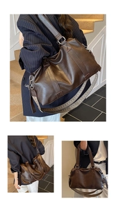 Detail of dark brown tote bag showing wide woven strap and soft leather texture