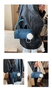 Detail of vintage baguette bag showing suede leather contrast and pearl chain accessories