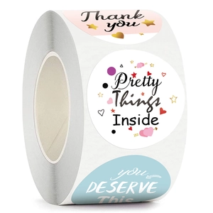 Roll of round thank you stickers with stars and hearts on pink and blue backgrounds