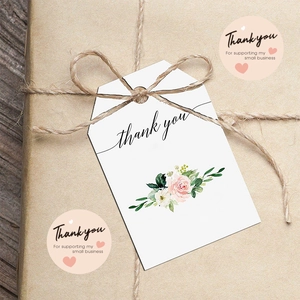 Floral thank you gift tags and round stickers set on rustic wood for craft packaging