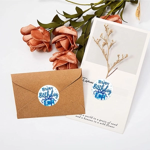 Blue and white Happy Birthday round adhesive stickers on envelopes with dried flowers