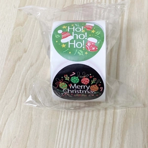 Detail view of round Christmas stickers with Merry Christmas and Ho Ho Ho text in packaging