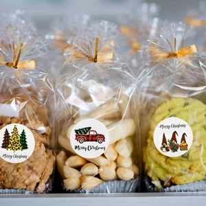 Close-up of festive Christmas stickers with Santa and truck motifs on cookie gift bags