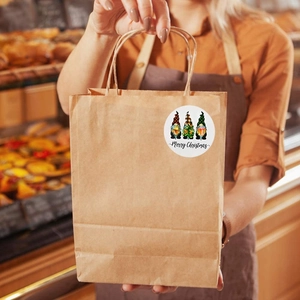 Christmas gnome stickers on kraft paper bags for festive gift packaging and holiday decor