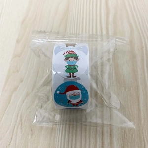 Detailed view of Christmas roll stickers featuring masked cartoon characters on wood