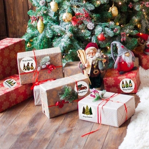 Merry Christmas roll stickers with Santa and gnome designs on holiday gift boxes