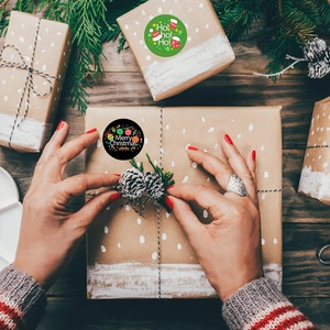 Christmas gift stickers featuring Ho Ho Ho and Merry Christmas text on kraft gift box