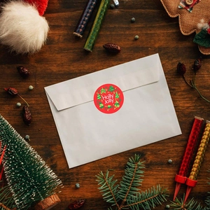 Red Holly Jolly Christmas stickers for gift wrapping on roll with pine tree design