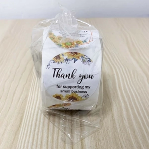 Close-up of thank you stickers with sunflower patterns for small business packaging