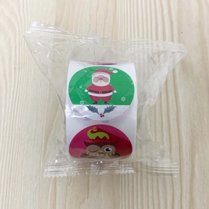 Detailed view of Christmas roll stickers featuring Santa and owl patterns in plastic wrap