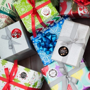 Roll of Christmas decorative stickers with Santa and reindeer motifs for gift packaging