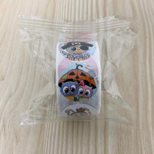 Roll of cartoon reward stickers with cat and owl designs for student praise