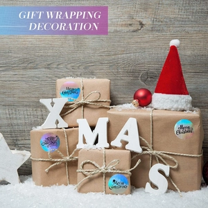 Holographic Merry Christmas roll stickers for gift wrapping on a festive wooden background