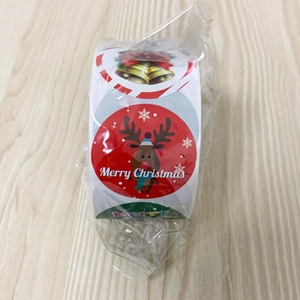 Close-up of Merry Christmas roll stickers featuring festive bells and reindeer patterns